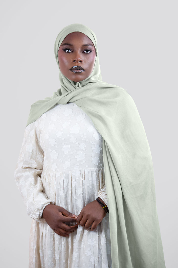 Woman wearing a light green  modal hijab 