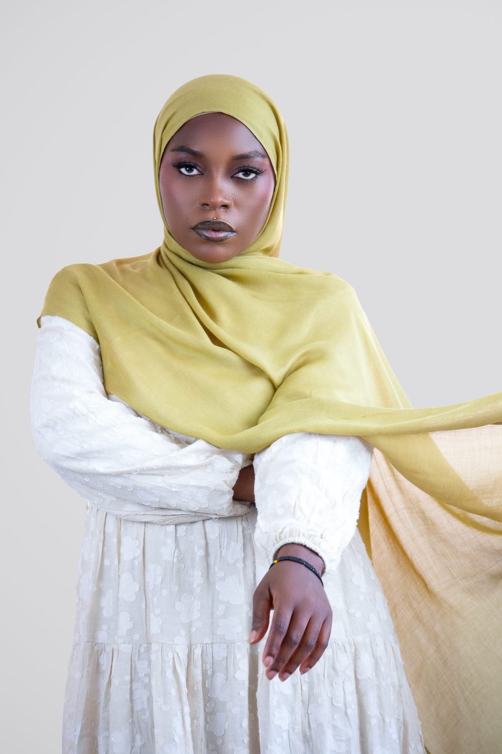 Woman wearing a yellow green modal hijab a