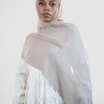 Woman wearing a modal hijab in taupe color 