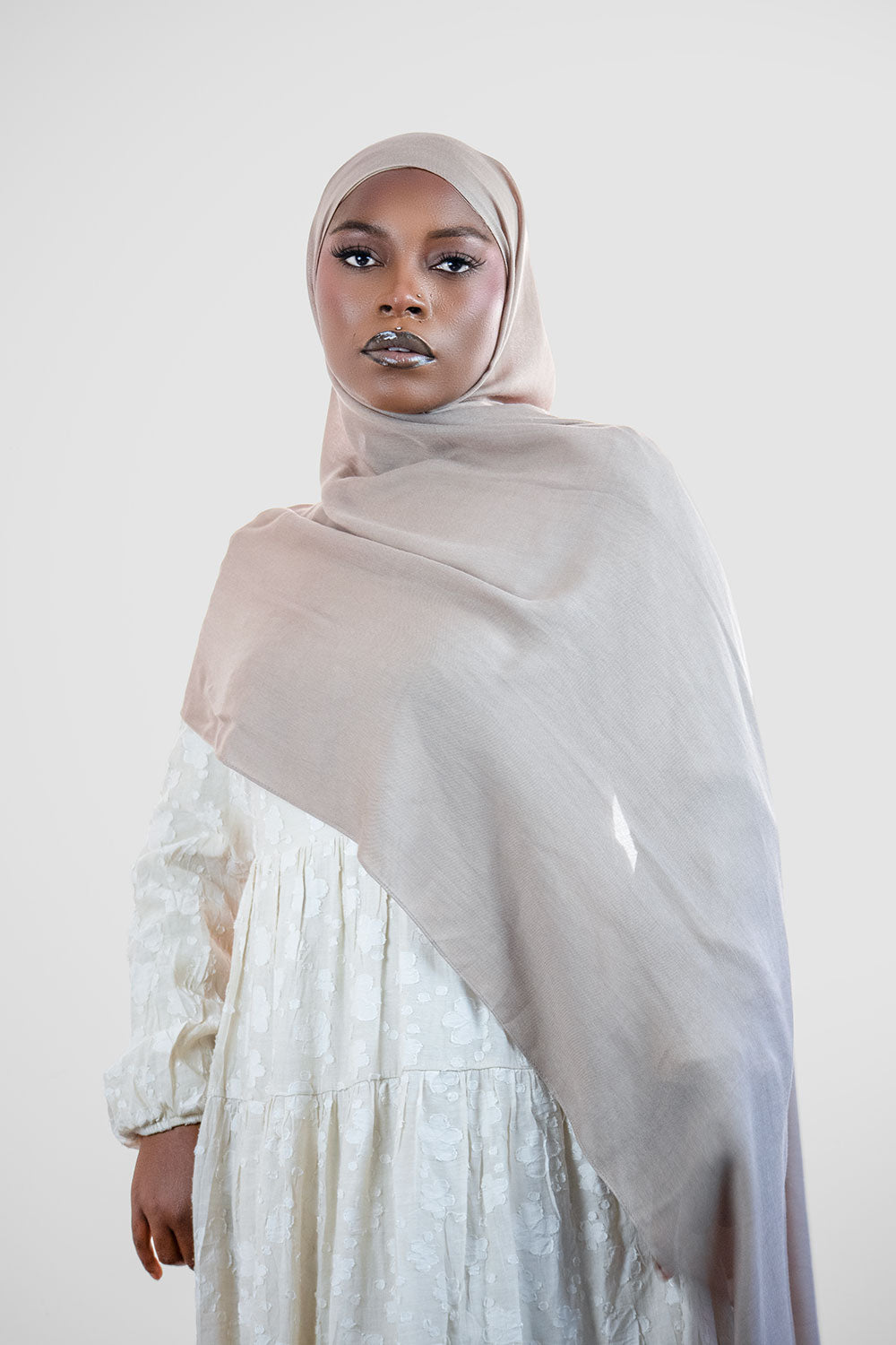 Woman wearing a modal hijab in taupe color