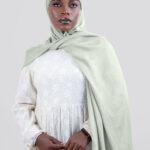 Woman wearing a light green  modal hijab 