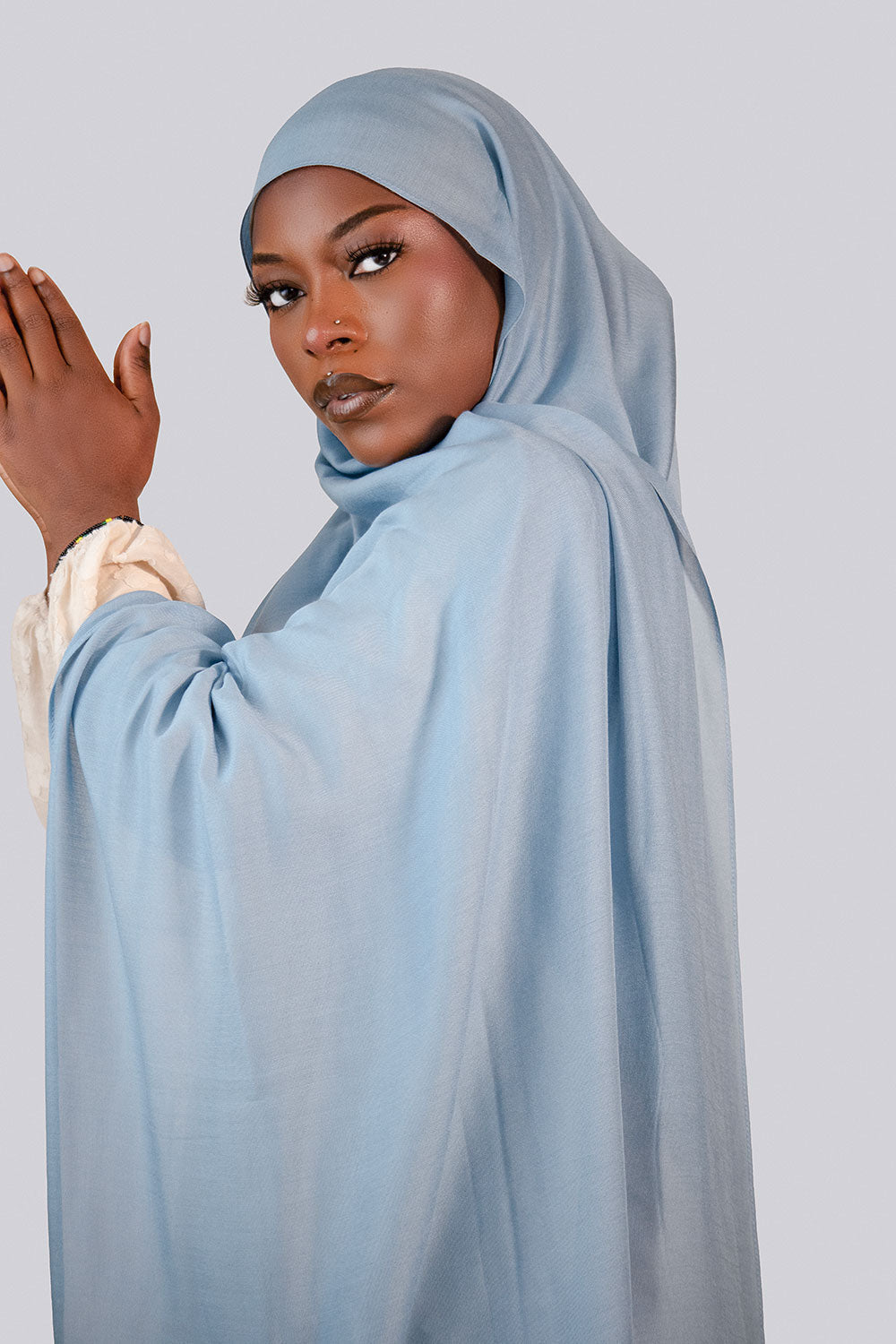 Woman wearing a light blue hijab modal