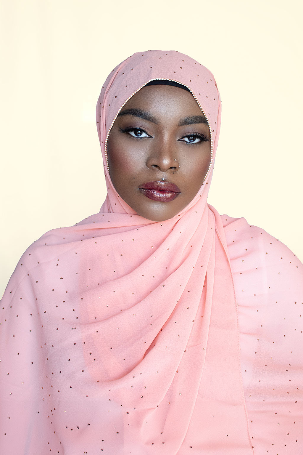 a lady is wearing orange diamond chiffon hijab